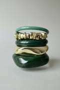 stack of acrylic resin and metal bangles in green and gold colors